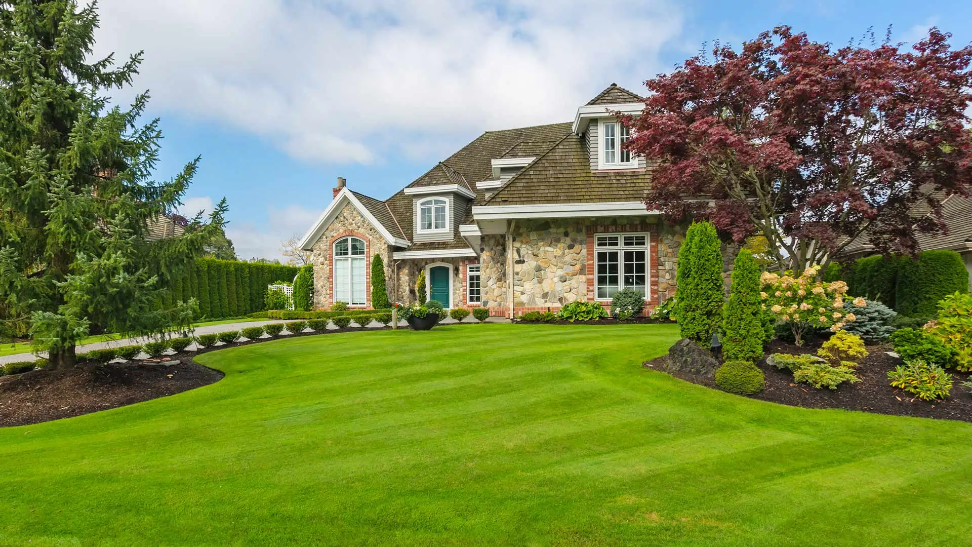 Stunning home with new landscape bed and mulch at the front door near Madison, OH.