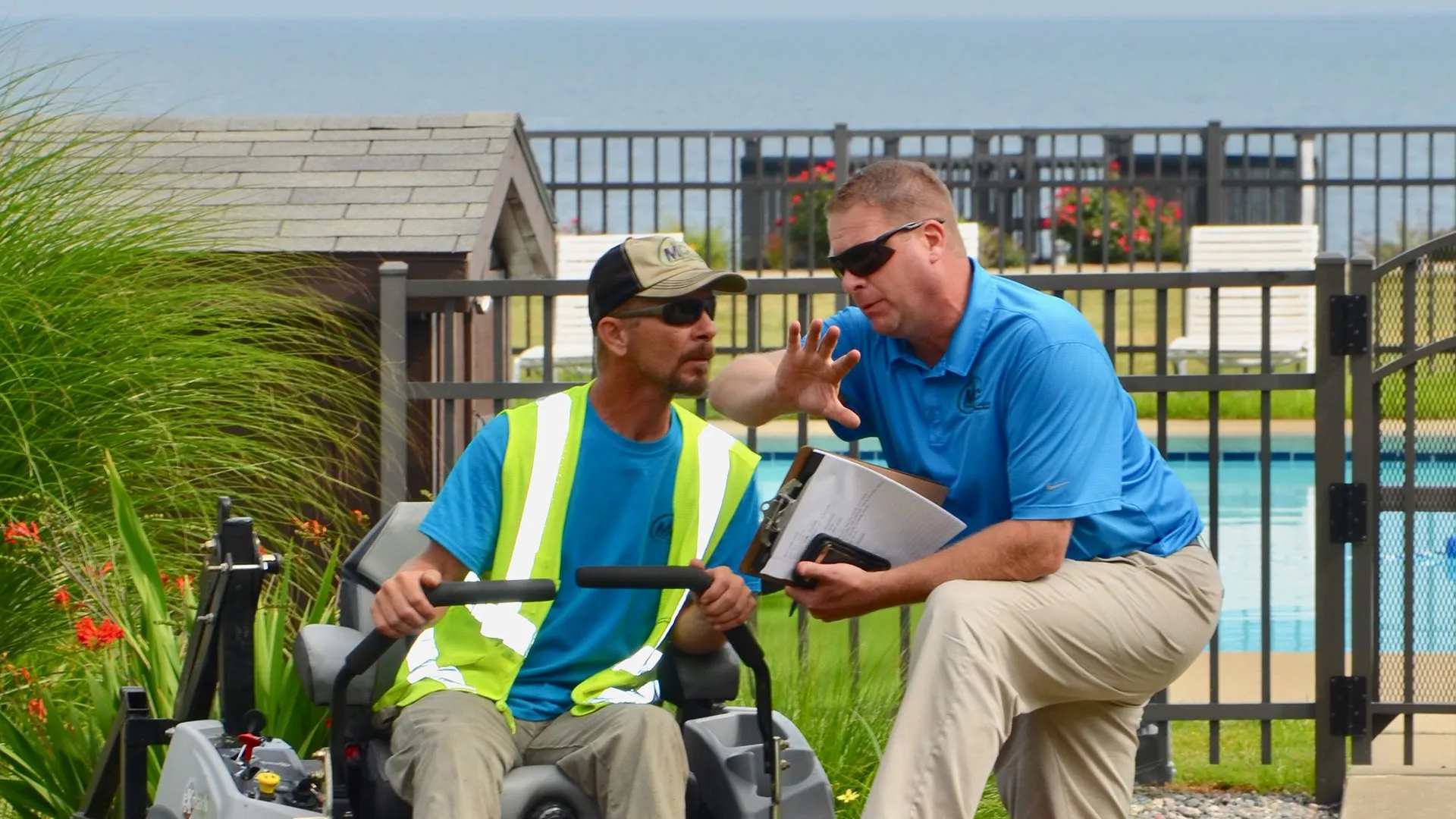 MC Professional Lawn Care and Snow Plowing manager and employee discussing a property.