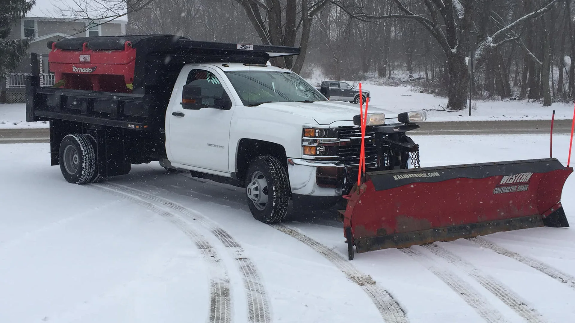 Snow plowing truck in a parking lot in and around the Madison, OH area.