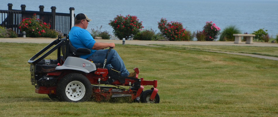 Professional mowing a lawn in Conneaut, OH.