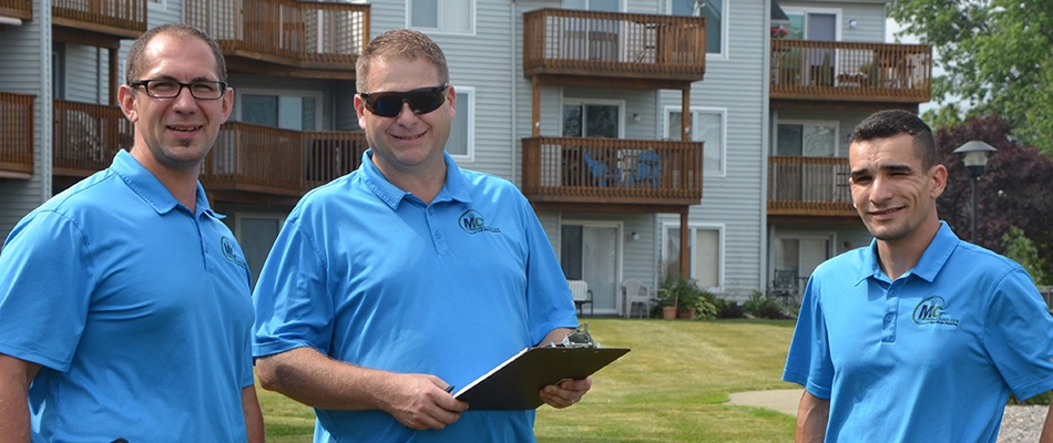 MC Professional Lawn Care and Snow Plowing managers inspecting a property together around Madison, OH.