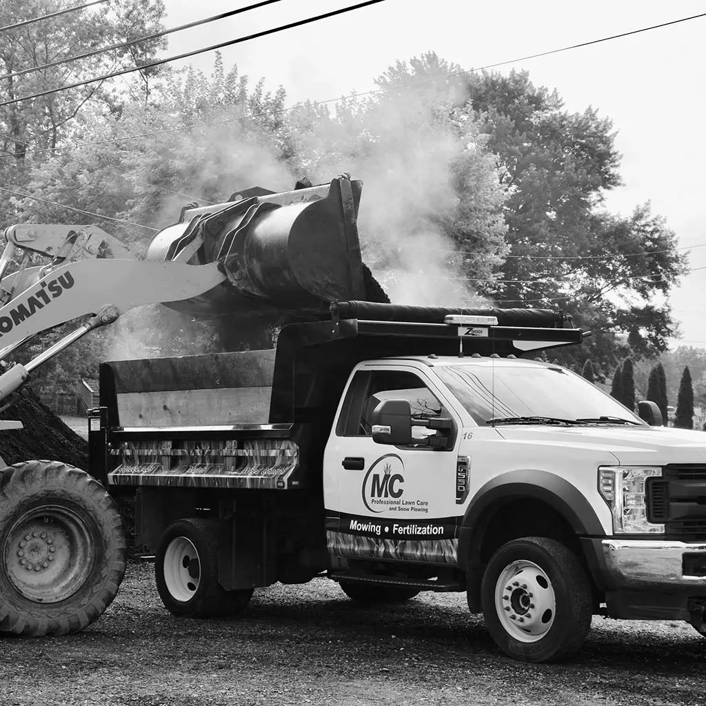 MC Professional Lawn Care and Snow Plowing truck and loader working on a job site near Madison, OH.