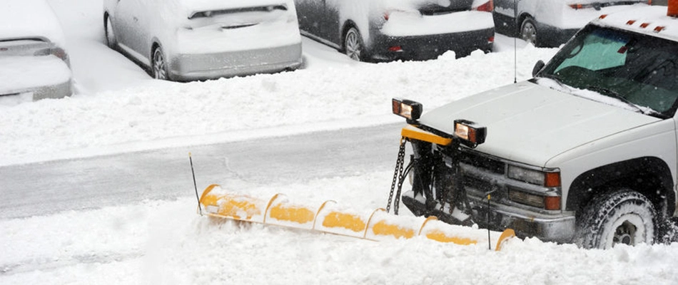 Parking lot with heavy snow fall being plowed by professionals in and around Madison, OH.