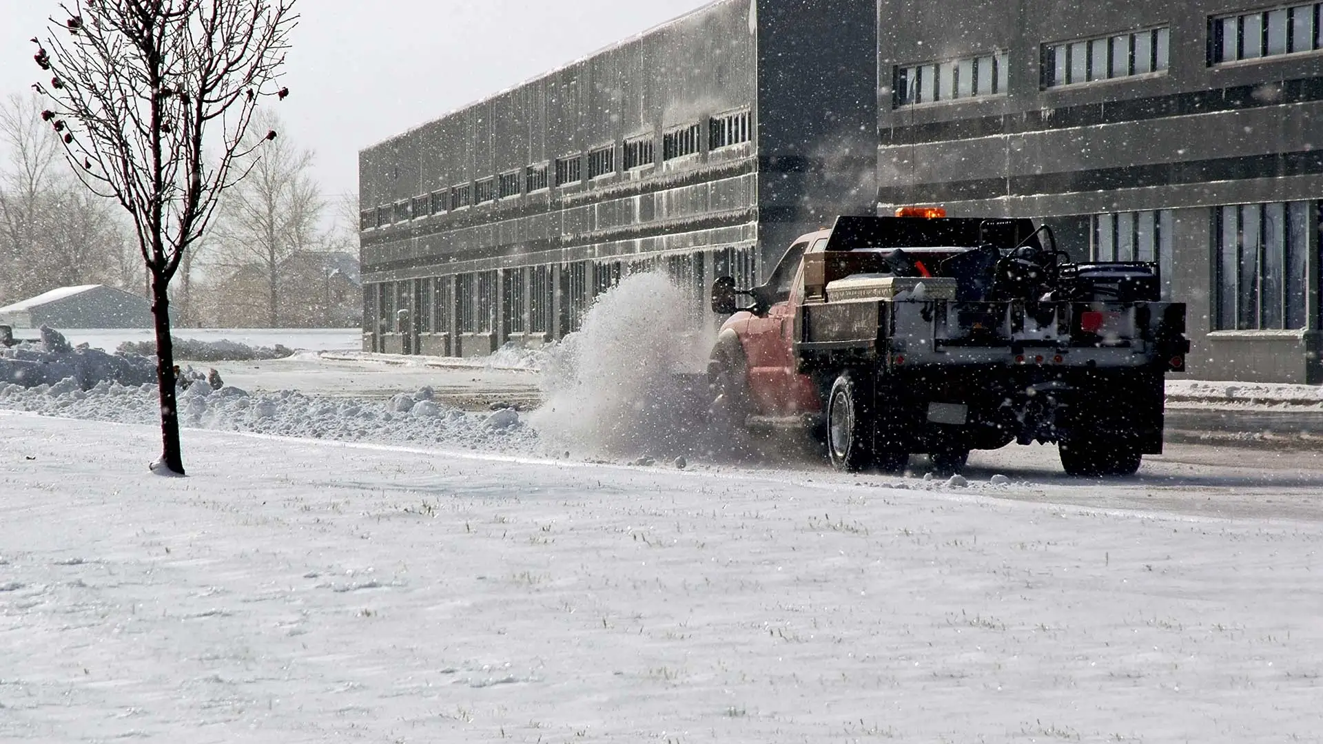 MC Professional Lawn Care and Snow Plowing snow plowing truck is removing snow from a commercial lot near Madison, OH.