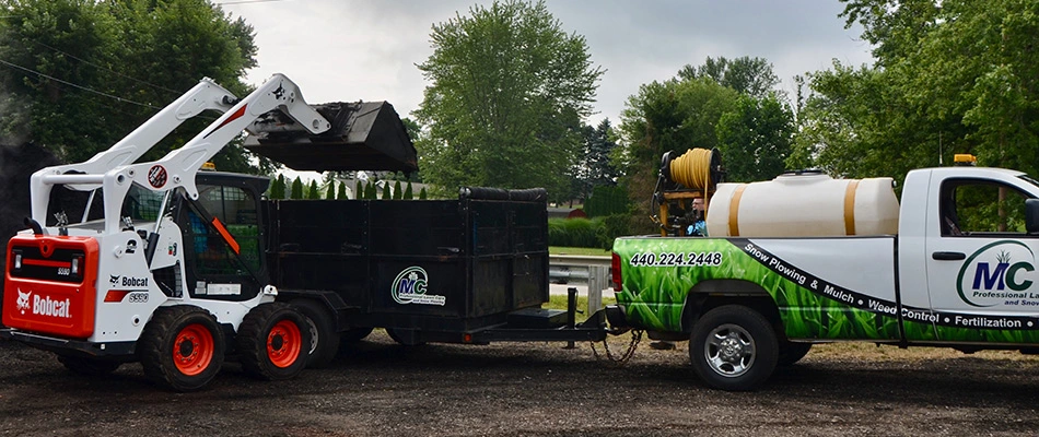 Rubber tire skid steer lading a trailer with dirt from a job near Madison, OH.